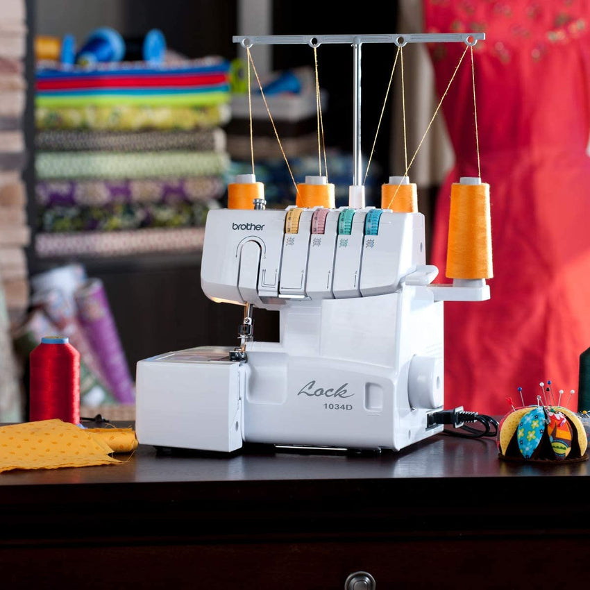 1034D Serger. Heavy-Duty Metal Frame Overlock Machine. 1.300 Stitches Per Minute. Removeable Trim Trap. 3 Included Accessory Feet